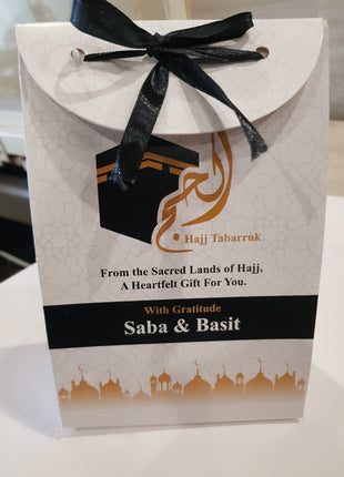 Hajj & Umrah Tabarruk Gift Set – Customized Bag, Tin Box & Zamzam Bottle (Complete Package)