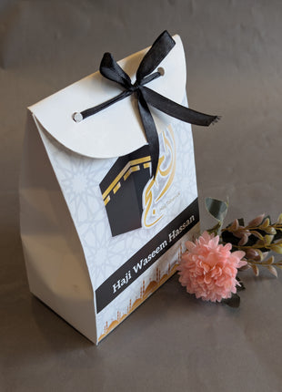 Hajj & Umrah Tabarruk Gift Set – Customized Bag, Tin Box & Zamzam Bottle (Complete Package)
