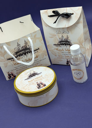 Hajj & Umrah Tabarruk Gift Set – Customized Bag, Tin Box & Zamzam Bottle (Complete Package)