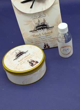 Hajj & Umrah Tabarruk Gift Set – Customized Bag, Tin Box & Zamzam Bottle (Complete Package)