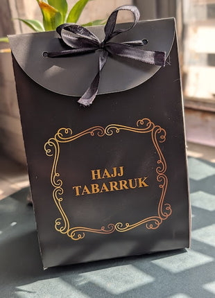 Hajj & Umrah Tabarruk Gift Set – Customized Bag, Tin Box & Zamzam Bottle (Complete Package)